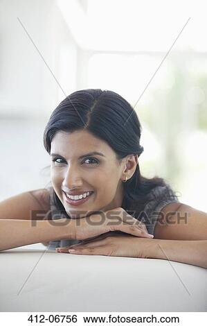 Businesswoman smiling on sofa View Large Photo Image Stock Photograph - Businesswoman smiling on sofa. Fotosearch