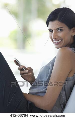 Businesswoman using cell phone View Large Photo Image Picture - Businesswoman using cell phone. Fotosearch