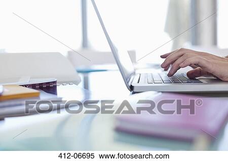 Businesswoman using laptop at desk View Large Photo Image Stock Photography - Businesswoman using laptop at desk. Fotosearch