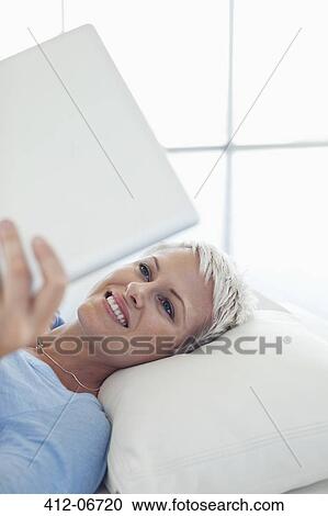 Stock Image - Businesswoman using tablet computer. Fotosearch