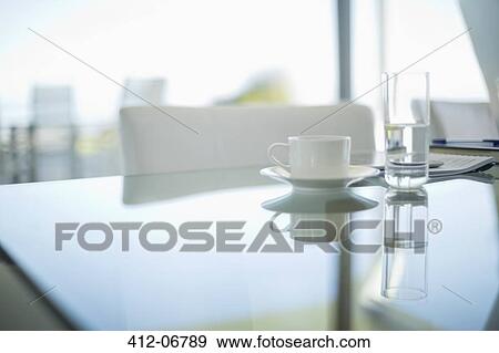 Coffee cup and water glass on meeting table View Large Photo Image Stock Photo - Coffee cup and water glass on meeting table. Fotosearch