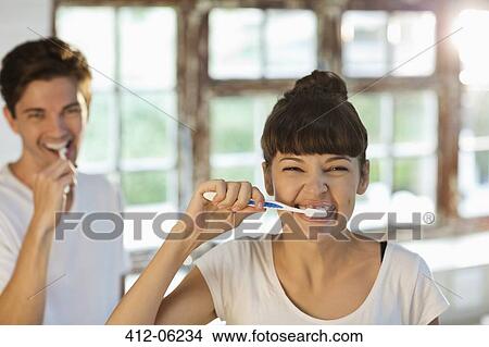 Couple brushing their teeth together View Large Photo Image Picture - Couple brushing their teeth together. Fotosearch