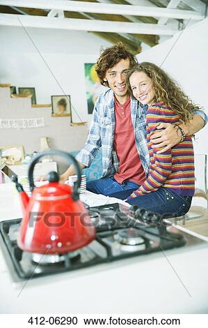 Couple hugging in kitchen View Large Photo Image Stock Image - Couple hugging in kitchen. Fotosearch