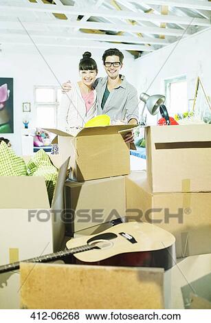 Couple hugging in new home View Large Photo Image Stock Photo - Couple hugging in new home. Fotosearch