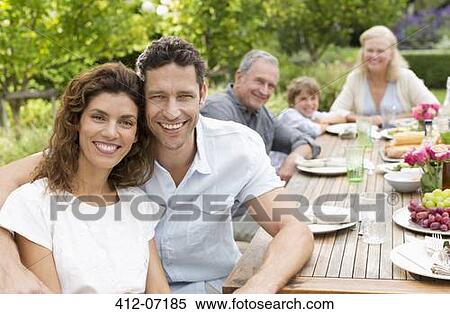 Couple smiling at table outdoors View Large Photo Image Stock Photography - Couple smiling at table outdoors. Fotosearch