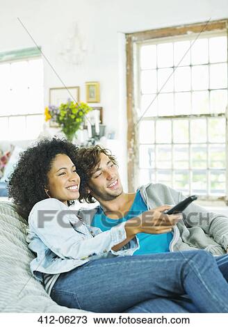 Couple watching television in beanbag chair View Large Photo Image Stock Image - Couple watching television in beanbag chair. Fotosearch
