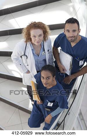 Stock Photo - Doctor and nurses on hospital steps. Fotosearch
