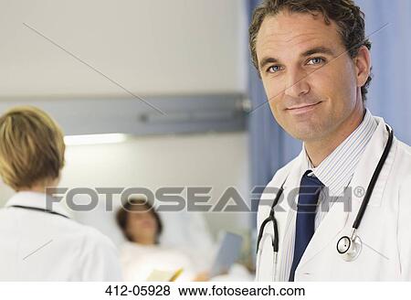 Doctor smiling in hospital room View Large Photo Image Stock Photo - Doctor smiling in hospital room. Fotosearch