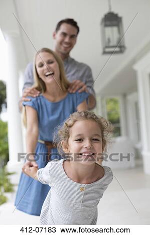 Stock Image - Family playing together on porch. Fotosearch