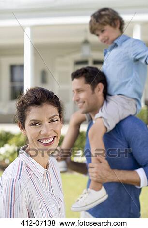 Family smiling outside house View Large Photo Image Stock Photo - Family smiling outside house. Fotosearch