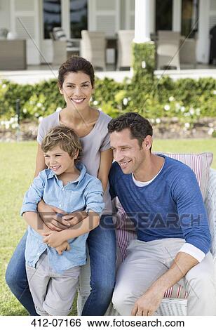 Family smiling outside house View Large Photo Image Stock Photograph - Family smiling outside house. Fotosearch