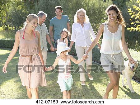 Family walking together in backyard View Large Photo Image Stock Photo - Family walking together in backyard. Fotosearch