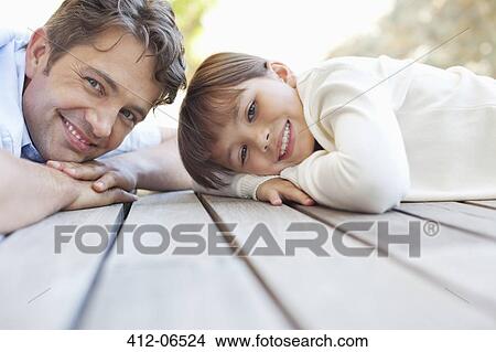 Father and daughter laying on porch View Large Photo Image Picture - Father and daughter laying on porch. Fotosearch