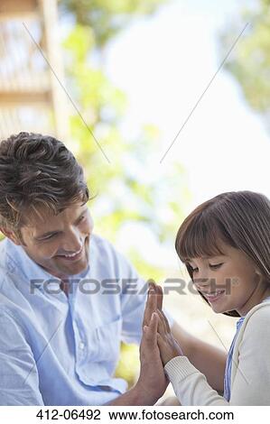 Father and daughter playing outdoors View Large Photo Image Stock Image - Father and daughter playing outdoors. Fotosearch