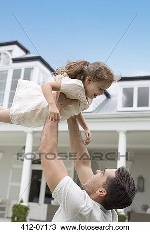 Father and daughter playing outdoors View Large Photo Image Stock Image - Father and daughter playing outdoors. Fotosearch
