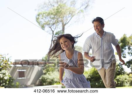 Father and daughter playing outdoors View Large Photo Image Stock Photograph - Father and daughter playing outdoors. Fotosearch