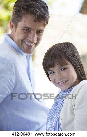 Father and daughter smiling outdoors View Large Photo Image Stock Photo - Father and daughter smiling outdoors. Fotosearch