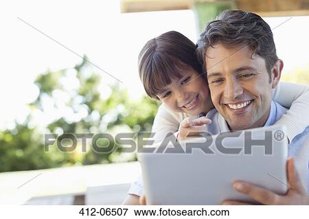 Father and daughter using tablet computer together View Large Photo Image Stock Photo - Father and daughter using tablet computer together. Fotosearch