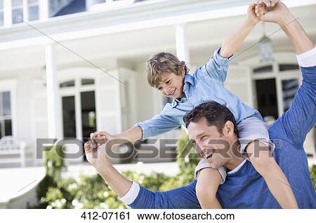 Father and son playing outside house View Large Photo Image Stock Image - Father and son playing outside house. Fotosearch