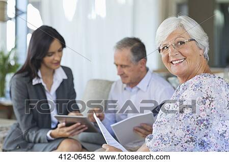 Financial advisor talking to couple on sofa View Large Photo Image Stock Image - Financial advisor talking to couple on sofa. Fotosearch