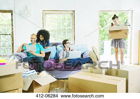 Picture - Friends relaxing in new home. Fotosearch