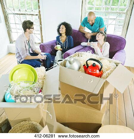 Friends relaxing in new home View Large Photo Image Stock Image - Friends relaxing in new home. Fotosearch
