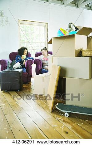 Friends relaxing in new home View Large Photo Image Stock Image - Friends relaxing in new home. Fotosearch