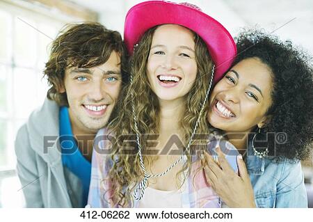 Friends smiling together indoors View Large Photo Image Stock Image - Friends smiling together indoors. Fotosearch