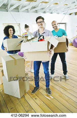 Friends unpacking boxes in new home View Large Photo Image Picture - Friends unpacking boxes in new home. Fotosearch