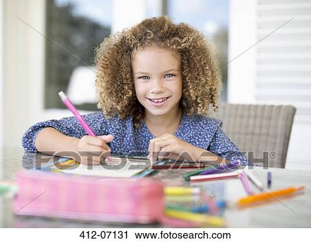 Girl coloring at table View Large Photo Image Stock Image - Girl coloring at table. Fotosearch