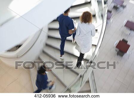 Hospital staff climbing spiral steps View Large Photo Image Stock Photograph - Hospital staff climbing spiral steps. Fotosearch