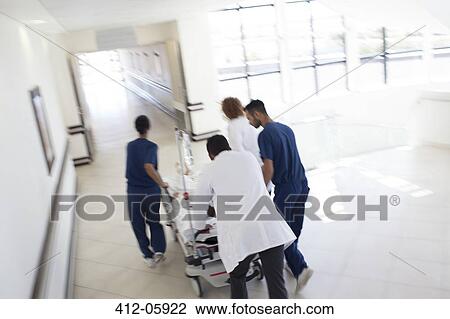 Hospital staff rushing patient to operating room View Large Photo Image Stock Image - Hospital staff rushing patient to operating room. Fotosearch