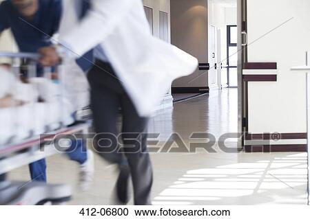 Hospital staff rushing patient to operating room View Large Photo Image Stock Image - Hospital staff rushing patient to operating room. Fotosearch