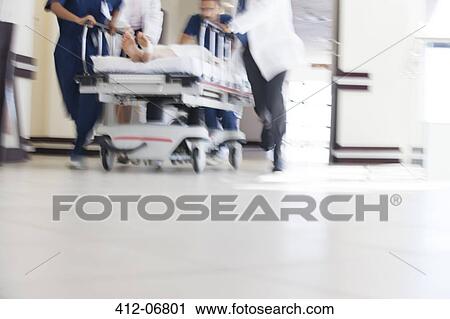 Hospital staff rushing patient to operating room View Large Photo Image Stock Image - Hospital staff rushing patient to operating room. Fotosearch