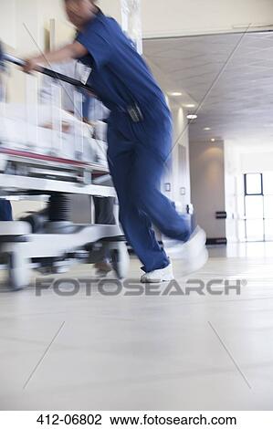 Hospital staff rushing patient to operating room View Large Photo Image Stock Image - Hospital staff rushing patient to operating room. Fotosearch