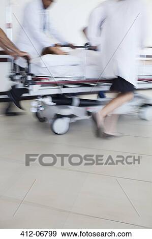 Hospital staff rushing patient to operating room View Large Photo Image Stock Photo - Hospital staff rushing patient to operating room. Fotosearch