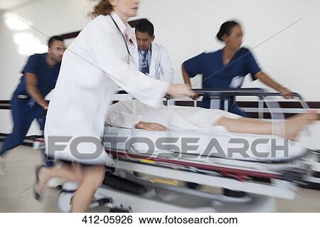 Hospital staff rushing patient to operating room View Large Photo Image Stock Photograph - Hospital staff rushing patient to operating room. Fotosearch