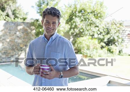 Man drinking cup of coffee outdoors View Large Photo Image Stock Image - Man drinking cup of coffee outdoors. Fotosearch