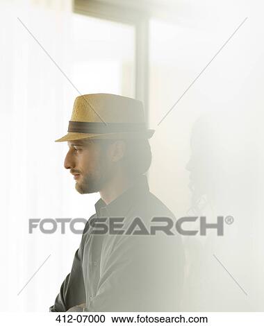 Man in straw hat looking out window View Large Photo Image Stock Image - Man in straw hat looking out window. Fotosearch