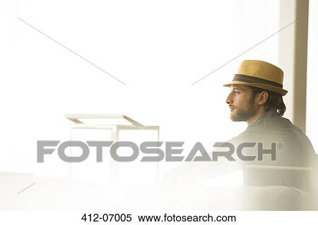 Man in straw hat looking out window View Large Photo Image Stock Photography - Man in straw hat looking out window. Fotosearch