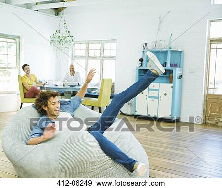 Man jumping into beanbag chair View Large Photo Image Stock Photo - Man jumping into beanbag chair. Fotosearch