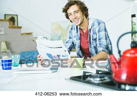 Man reading newspaper in kitchen View Large Photo Image Stock Image - Man reading newspaper in kitchen. Fotosearch