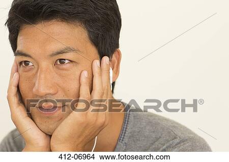 Picture - Man resting chin in hands. Fotosearch