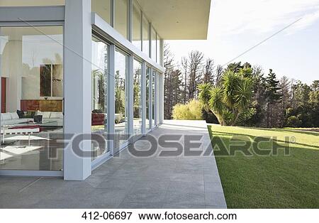 Stock Photo - Modern building overlooking manicured lawn. Fotosearch