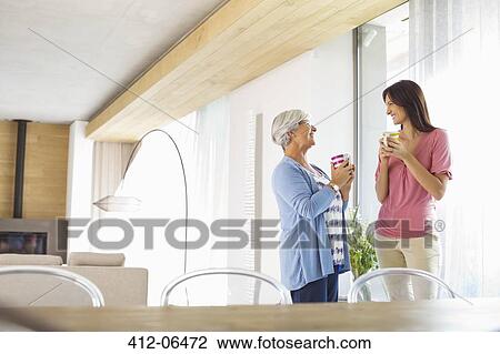 Mother and daughter having cup of coffee View Large Photo Image Stock Image - Mother and daughter having cup of coffee. Fotosearch