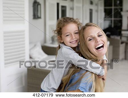 Stock Photo - Mother and daughter playing on porch. Fotosearch