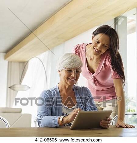 Mother and daughter using tablet computer View Large Photo Image Stock Photography - Mother and daughter using tablet computer. Fotosearch