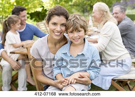 Mother and son smiling in backyard View Large Photo Image Stock Photo - Mother and son smiling in backyard. Fotosearch