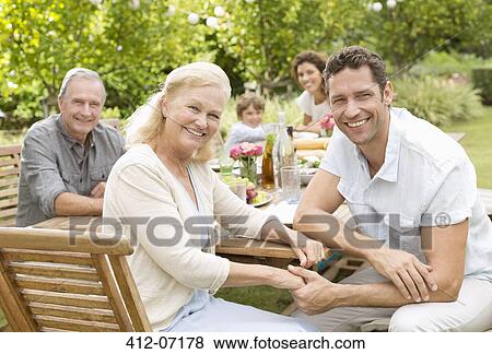 Stock Photo - Mother and son smiling in backyard. Fotosearch