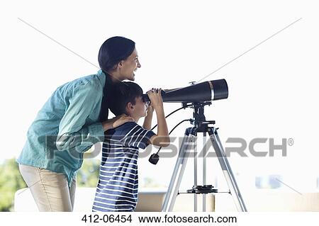 Mother and son using telescope View Large Photo Image Picture - Mother and son using telescope. Fotosearch